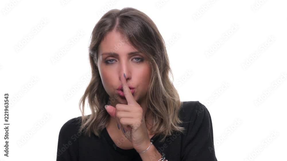 Beautiful blue eyed young woman with finger on lips silence or quiet gesture isolated on white background Beautiful blue eyed young woman with finger on lips silence or quiet gesture isolated on white background