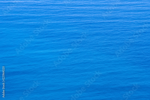 Aerial view of the clear blue sea surface on a bright sunny day.
