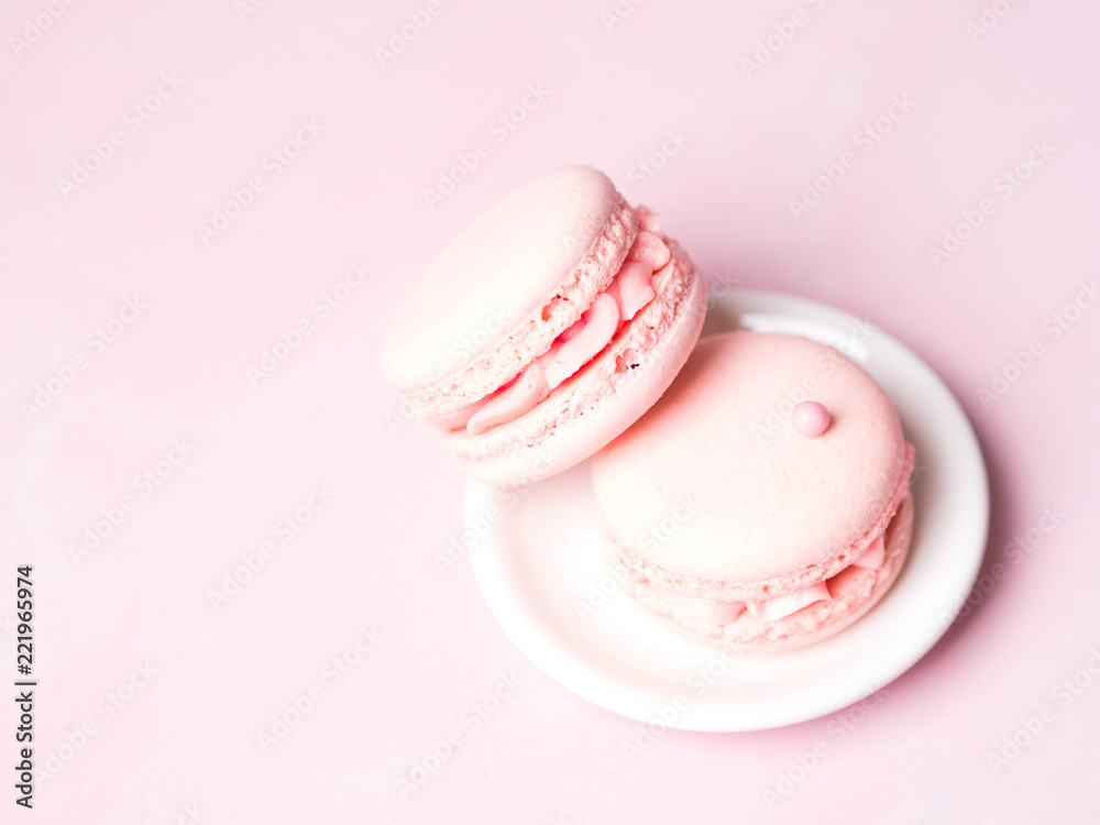 Fototapeta premium Pink colorful cake macaroon on pastel background, colorful almond cookies