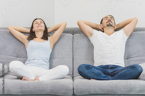 Happy couple relaxing on the couch at home in the living room