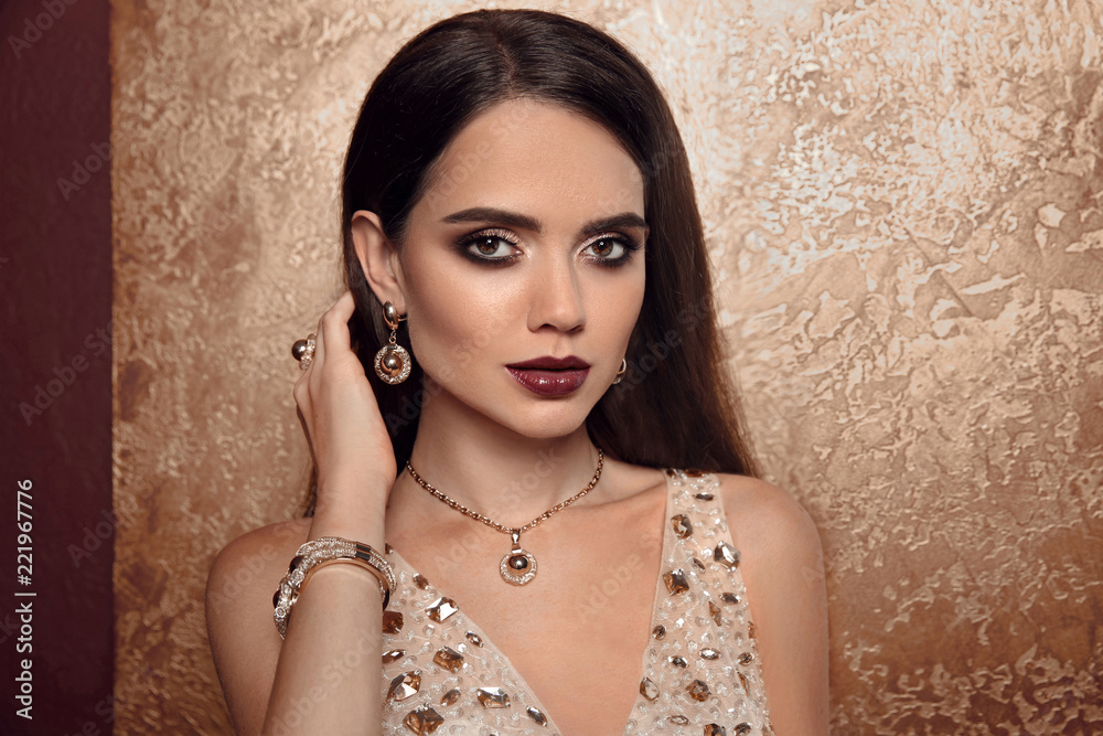 Jewelry Fashion. Woman In Luxury Jewels. Glamour Female Model With Beauty  Face Makeup Wearing Expensive Gold Jewelry And Stylish Beige Dress. High  Quality Style. Stock Photo | Adobe Stock