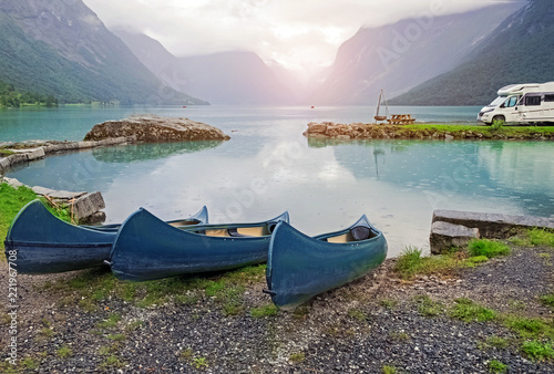 Three kayaks standing near the scenic mountain lake. © Diana Vyshniakova