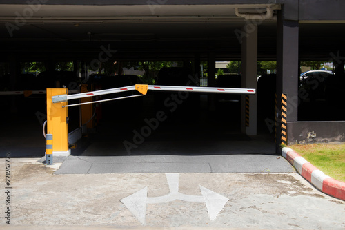 car park barrier, automatic entry system.Security system for building access - barrier gate stop with toll booth, traffic cones and cctv photo