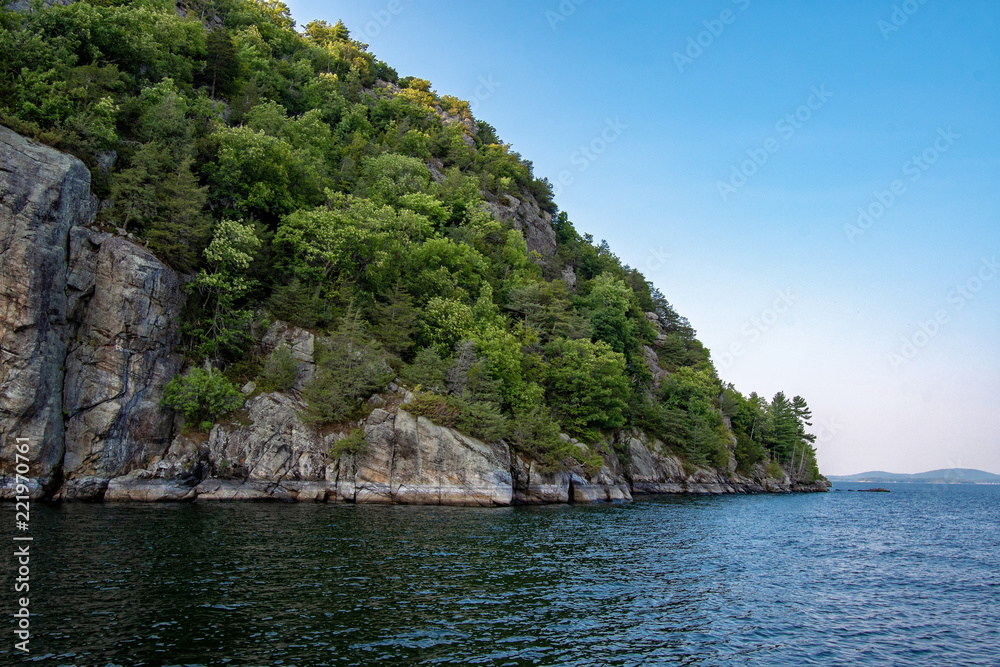 Cliff with trees on the edge of the Lake Champlain
