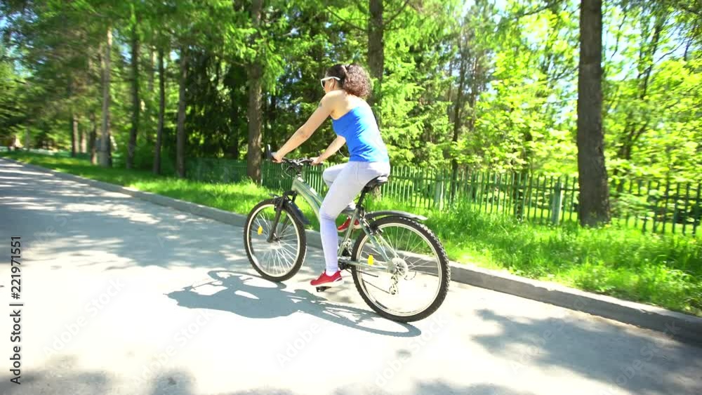 Biking woman cycling on bike. Sporty woman riding bicycle in summer day. Female cyclist outdoor activity living healthy lifestyle. summer time 4K Biking woman cycling on bike. Sporty woman riding bicycle in summer day. Female cyclist outdoor activity living healthy lifestyle. summer time 4K