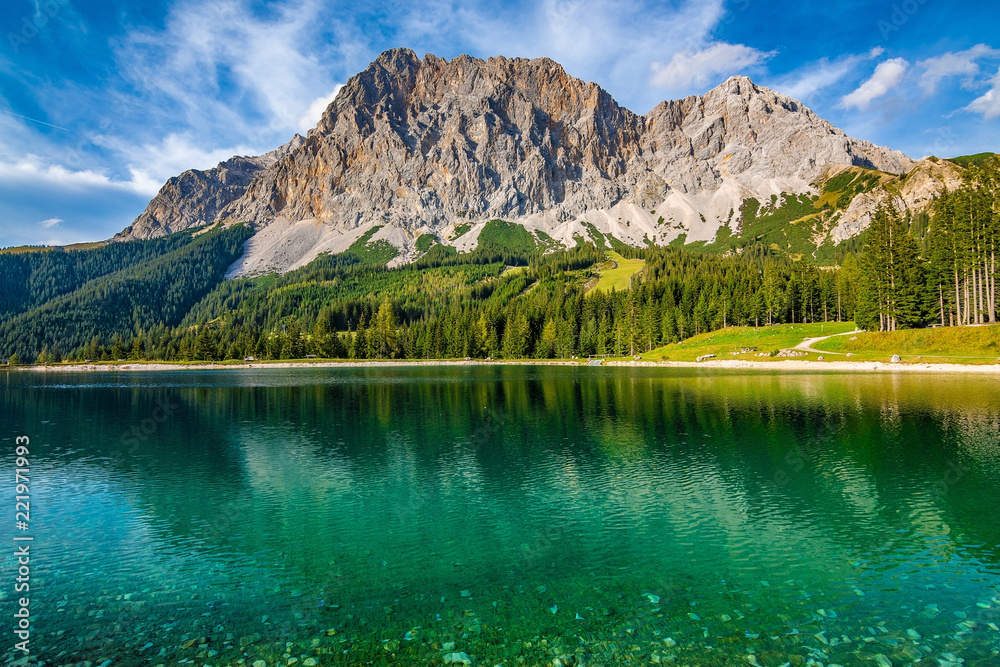 A beautiful view on the Ehrwalder Almsee and the Zugspitze on a sunny summer day in Austria, September 2018