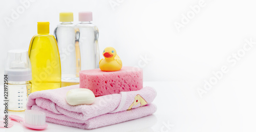 Still life with baby hygiene and bath items, shampoo bottle, essential oil, baby soap, towel, pacifier, rubber toy, shower puff. Copy space for your text