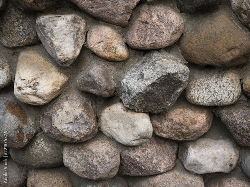 Wall of large bulk stones. Colourful big stones. 