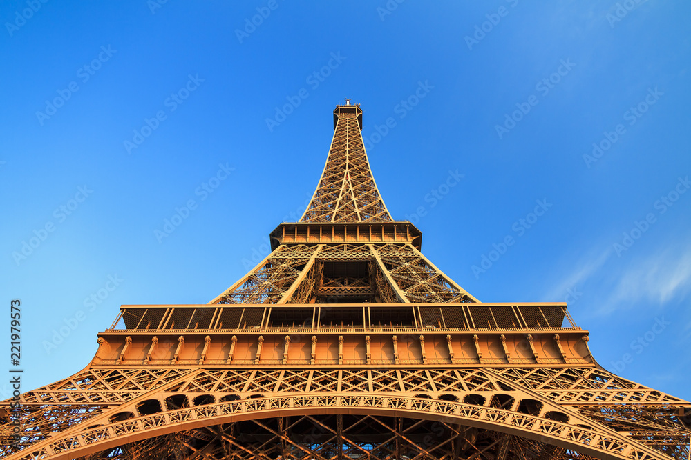 Beautiful view of the Eiffel tower seen from beneath in the golden hour in Paris