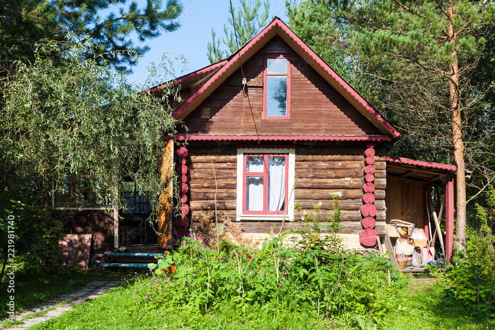 Fototapeta premium front view of country log house on summer day