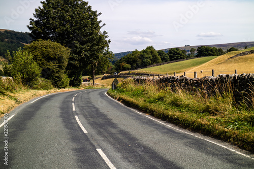 A road running through the Yorkshire Dales in the English countryside