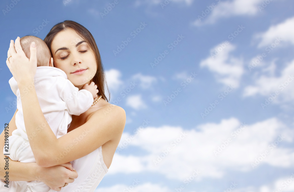 family and motherhood concept - happy smiling young mother with little baby over sky background