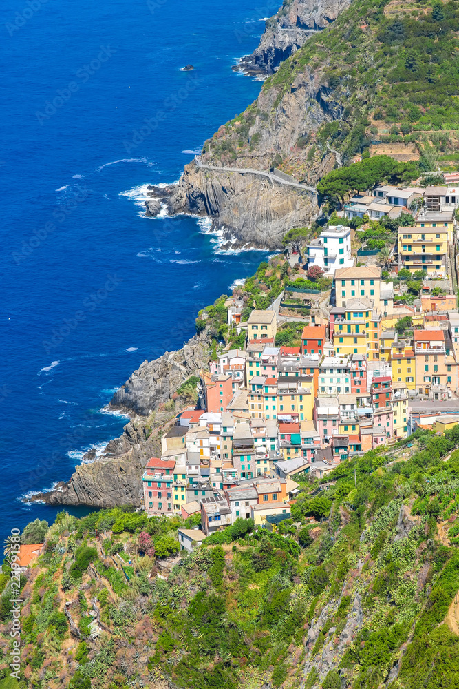View over the the historic architecture of Cinque Terre, Italy with colourful houses on a sunny day.