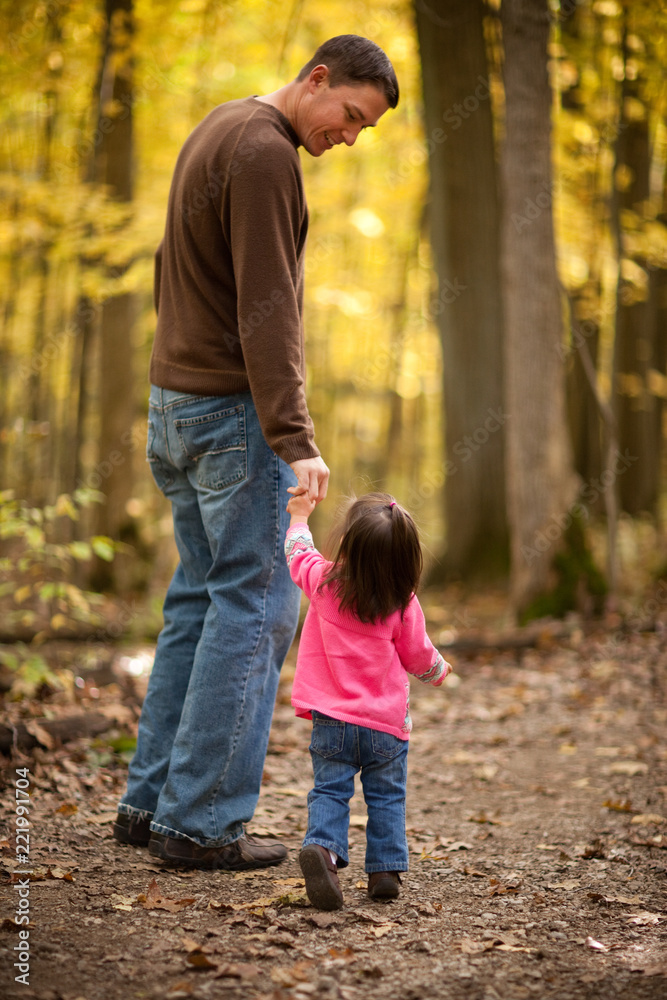 Father and Daughter Walking in Autumn Woods Father and Daughter Walking in Autumn Woods