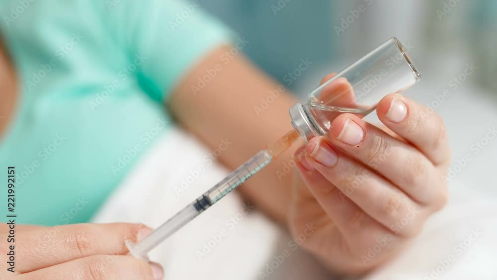 Closeup 4k video of young woman with diabetes filling insulin syringe from ampoule Closeup 4k video of young woman with diabetes filling insulin syringe from ampoule