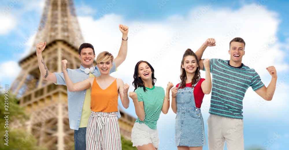 travel, tourism and summer holidays concept - group of happy smiling friends making fist pump gesture over eiffel tower background travel, tourism and summer holidays concept - group of happy smiling friends making fist pump gesture over eiffel tower background