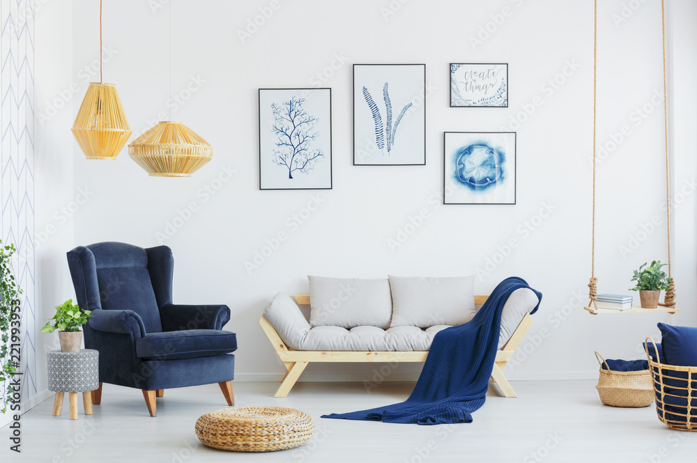 Blue Armchair Next To A Grey Sofa