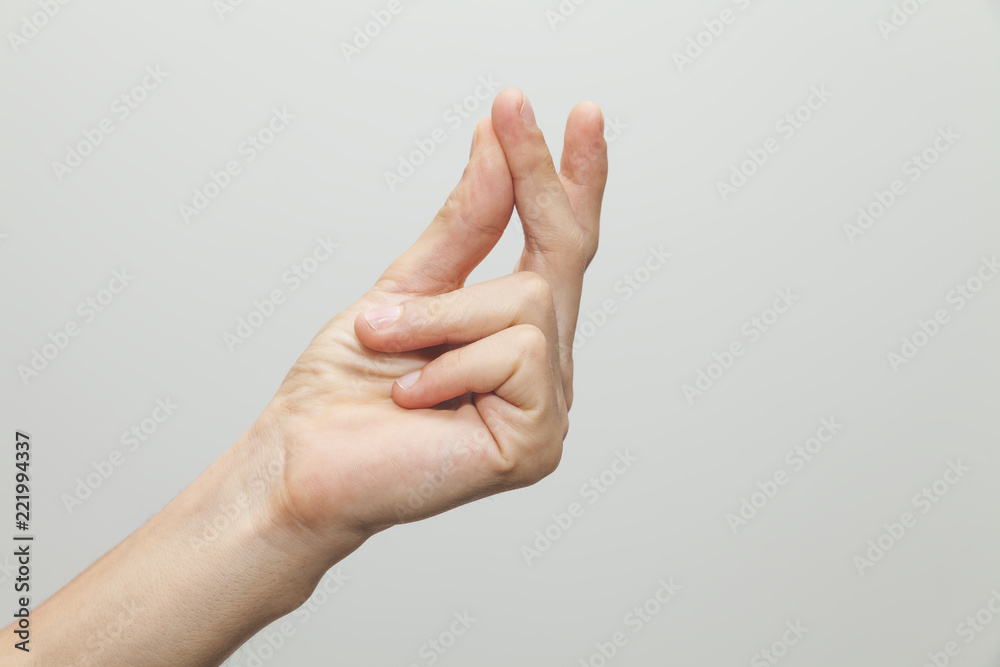 Male hand showing ''snap'' gesture, snapping or clicking with two fingers