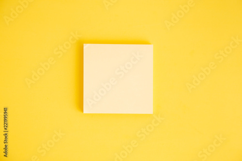 Set of yellow stick paper notes on color background.