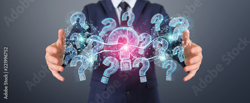 Businessman solving problem with digital question marks 3D rendering photo