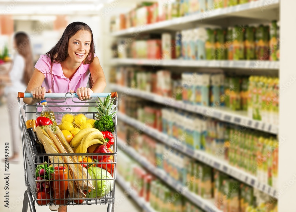 Close-up portrait of happy young woman in grocery shop
