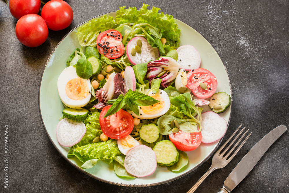Fresh salad from vegetables and eggs for proper nutrition. Summer food. Diet for weight loss concept. Fresh salad from vegetables and eggs for proper nutrition. Summer food. Diet for weight loss concept.