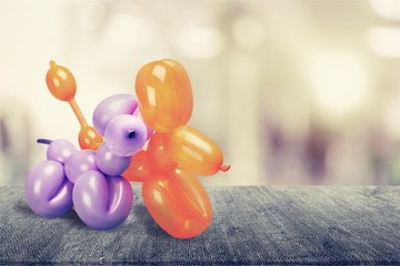 Two balloons in shape of animals on background