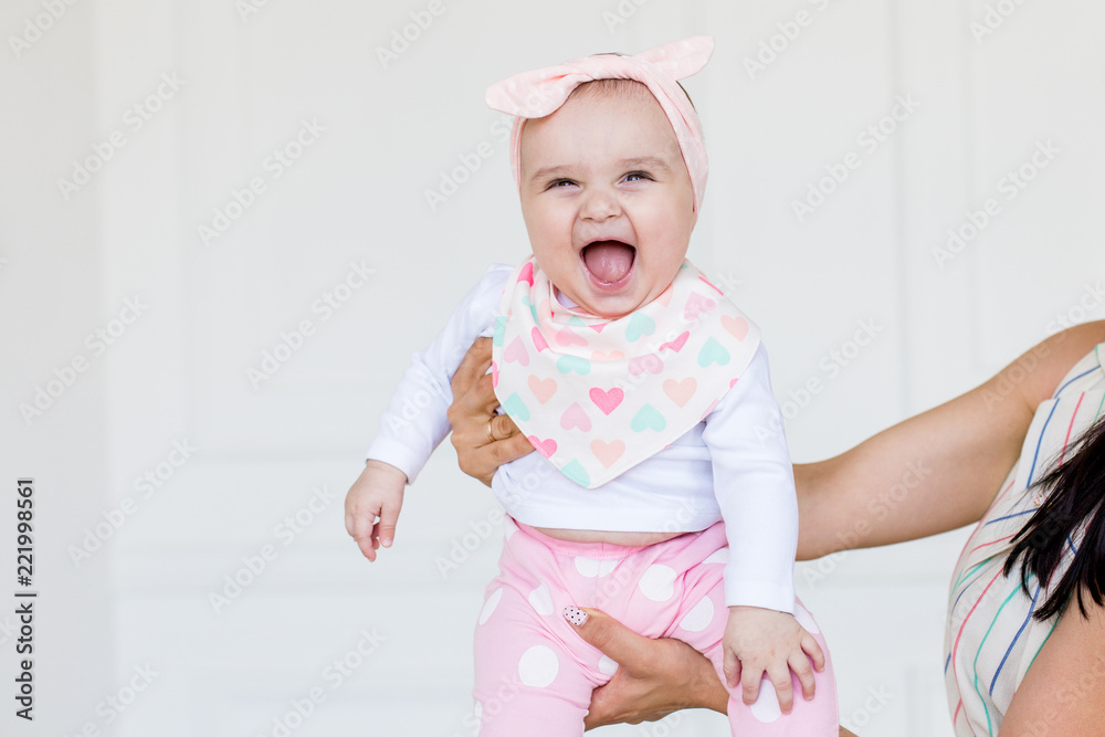 Smiling Infant Baby 6 Month Old. Cute little girl in modern clothes. Happy baby looking at camera Smiling Infant Baby 6 Month Old. Cute little girl in modern clothes. Happy baby looking at camera