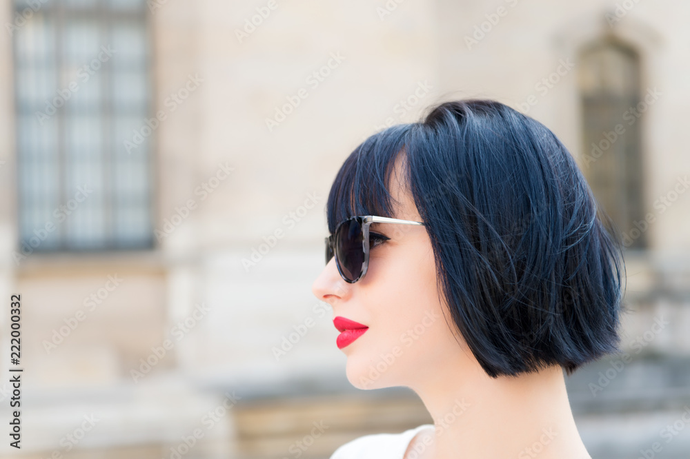 Girl fashionable lady with bob hairstyle outdoor urban architecture background. Woman fashionable model posing outdoor. Girl brunette bob hairstyle looks stylish. Hair styling tips from hairdresser
