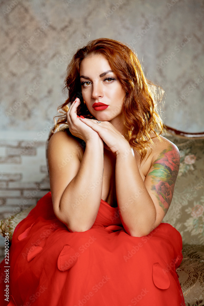 Naklejka premium beautiful young woman wearing a red dress