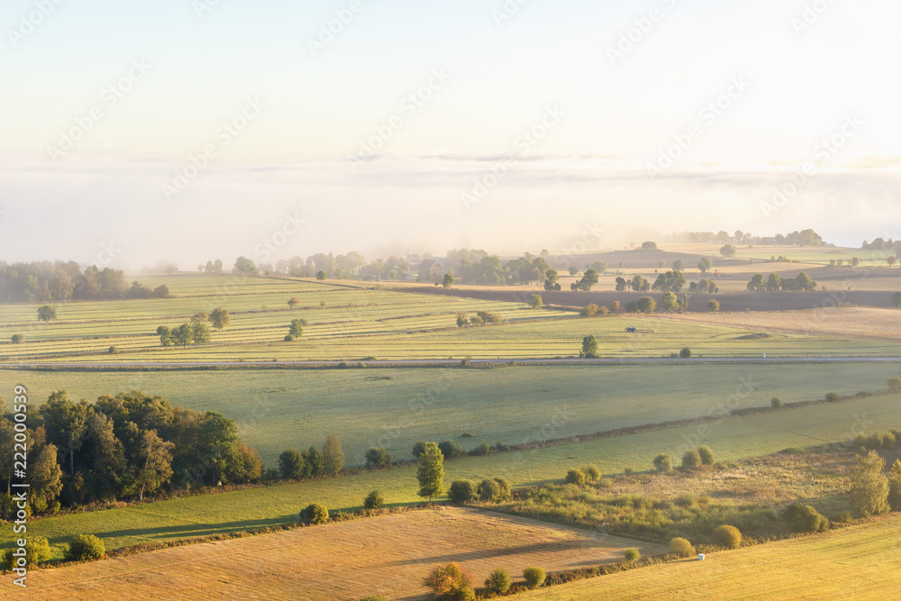 Aerial view over a agricultural landscape in autumn fog