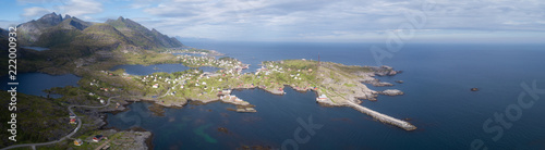 Beautiful aerial panorama of the blue sea surrounding the fishing village and rocky peaks Reine, Moskenes, Lofoten, Norway, sunny arctic summer