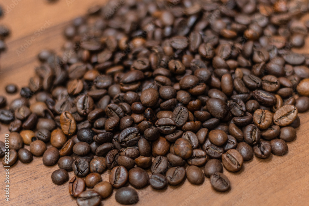 Background of fried coffee beans on a wooden surface Background of fried coffee beans on a wooden surface