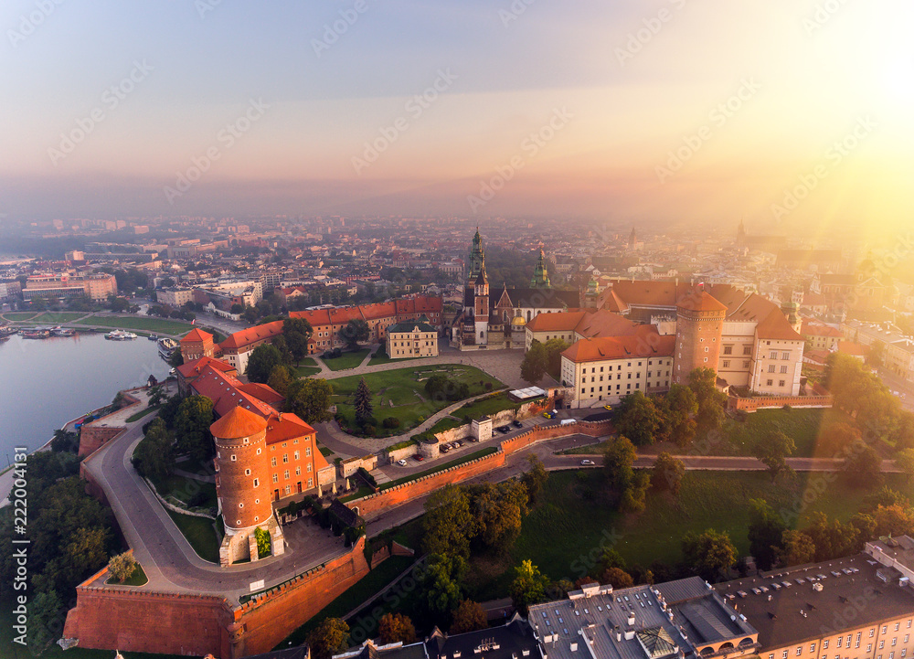 Fototapeta premium Aerial view Royal Wawel Castle and Gothic Cathedral in Cracow, Poland, with Renaissance Sigismund Chapel with golden dome, fortified walls, yard, park and tourists.