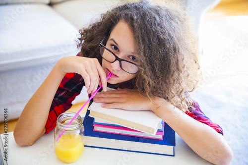 Curly hair teen girl drinks...