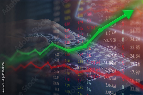 Investing and stock market concept gain and profits with faded candlestick charts in dark concept design.  Upward gains and massive profits.