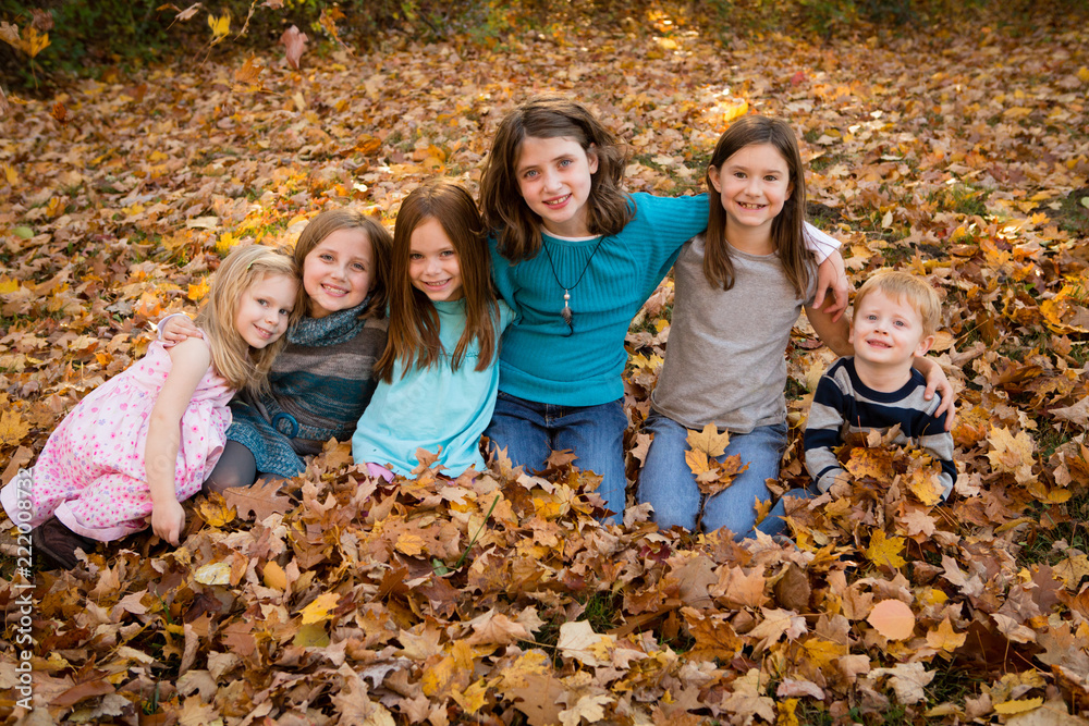 Group of Happy Children in Autumn Leaves Group of Happy Children in Autumn Leaves