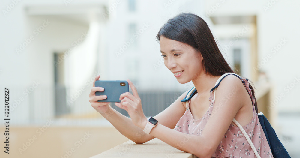 Woman taking photo on cellphone in Shum Yip upperhills