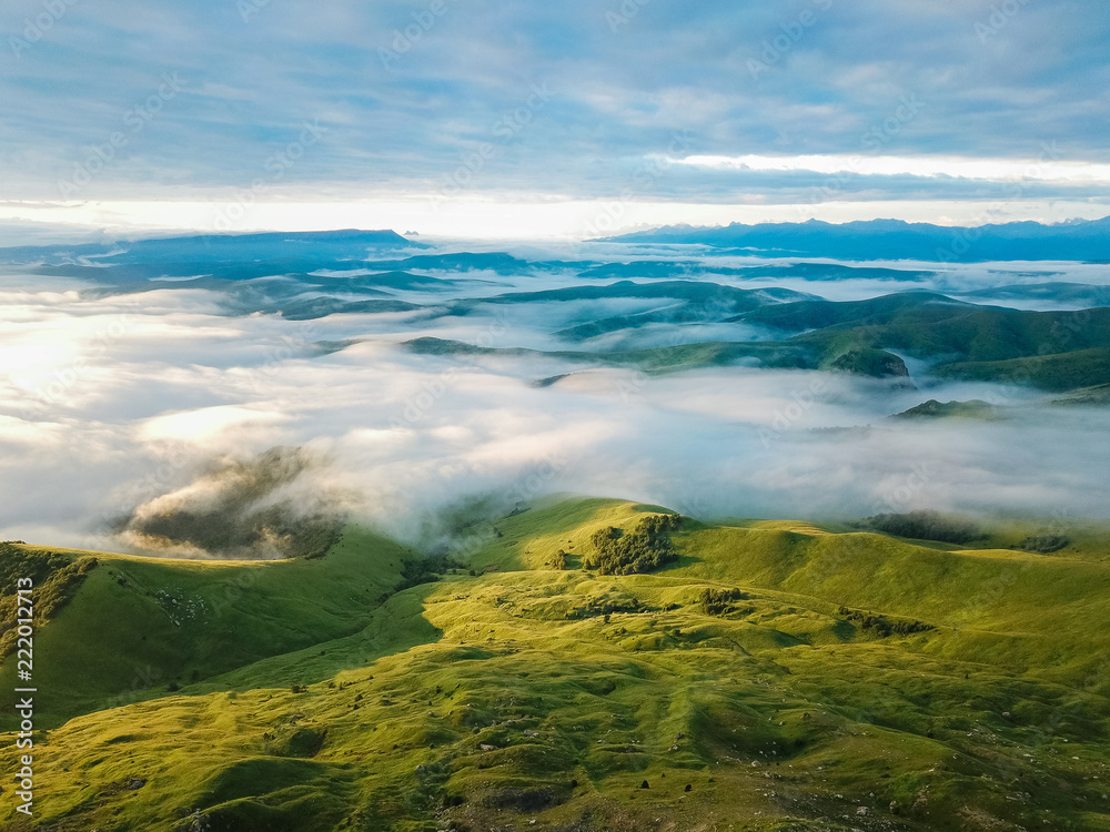 Aerial view from the drone. The peaks of the North Caucasus mountains in the morning fog at dawn.