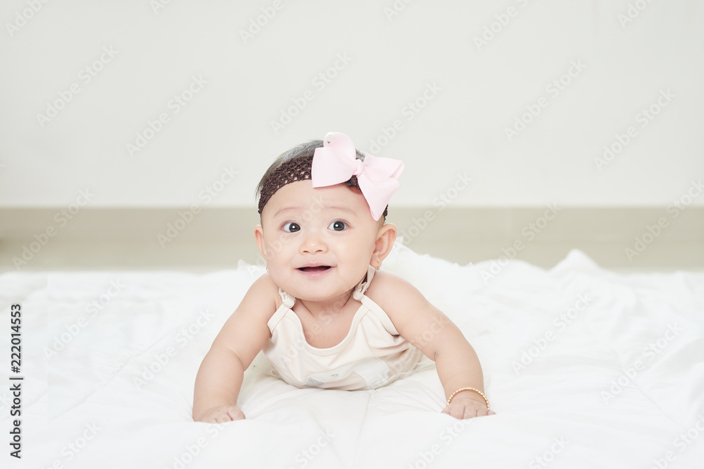 Baby girl smiling on the floor isolated on white Baby girl smiling on the floor isolated on white