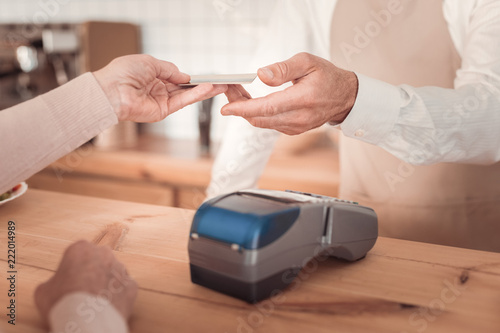 Payment for the order. Close up of a credit card being used for payment for the order in the cafeteria