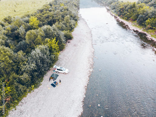 aerial view of car camping near mountain river