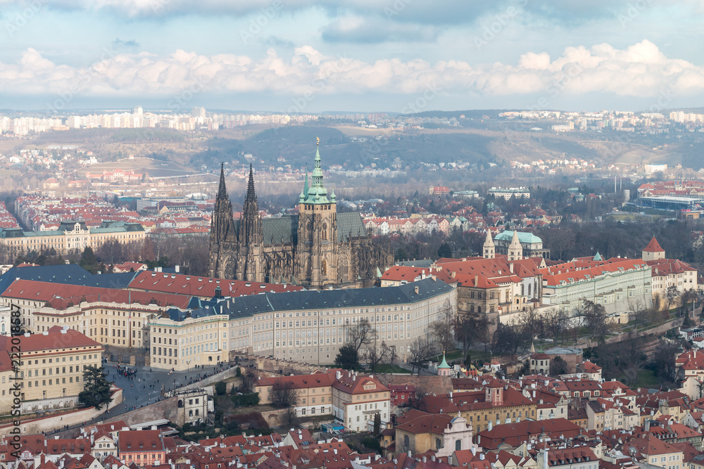 View of Prague Castle and St. Vitus Cathedral. Beautiful Prague cityscape with classic red roofs and famous medieval gothic church.
