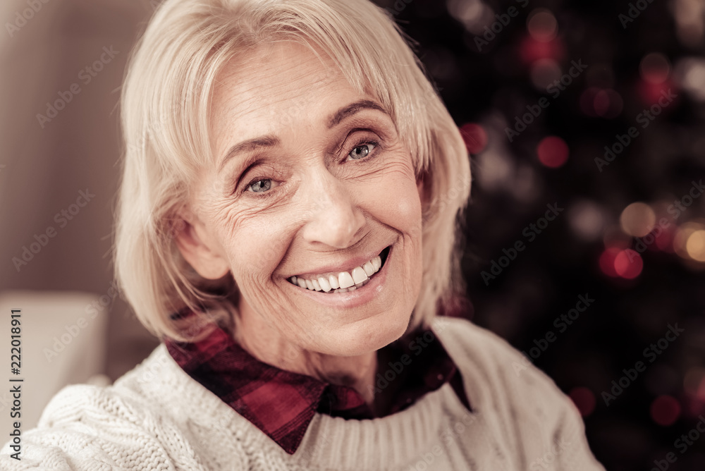 Be happy. Satisfied aged cute woman being in the empty room looking straight and smiling. Be happy. Satisfied aged cute woman being in the empty room looking straight and smiling.
