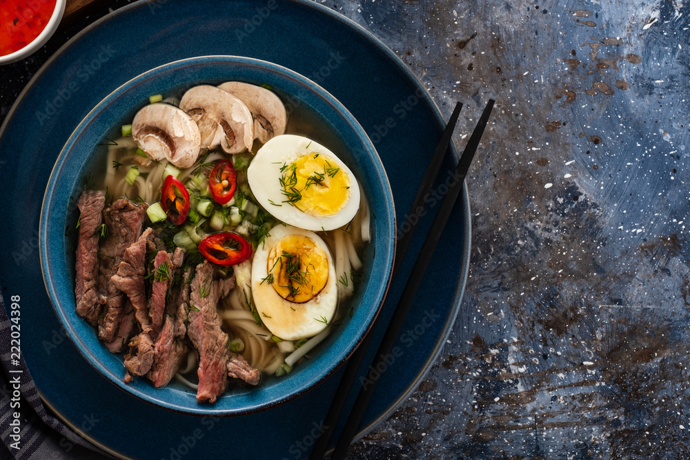 Traditional Asian cuisine. Ramen soup with beef, mushrooms and egg