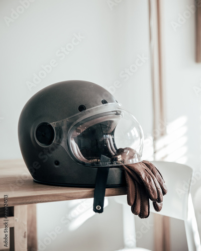 Motorcycle helmet and gloves on table photo