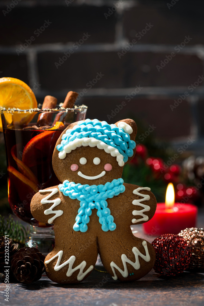 Christmas composition with mulled wine and gingerbread man, vertical closeup
