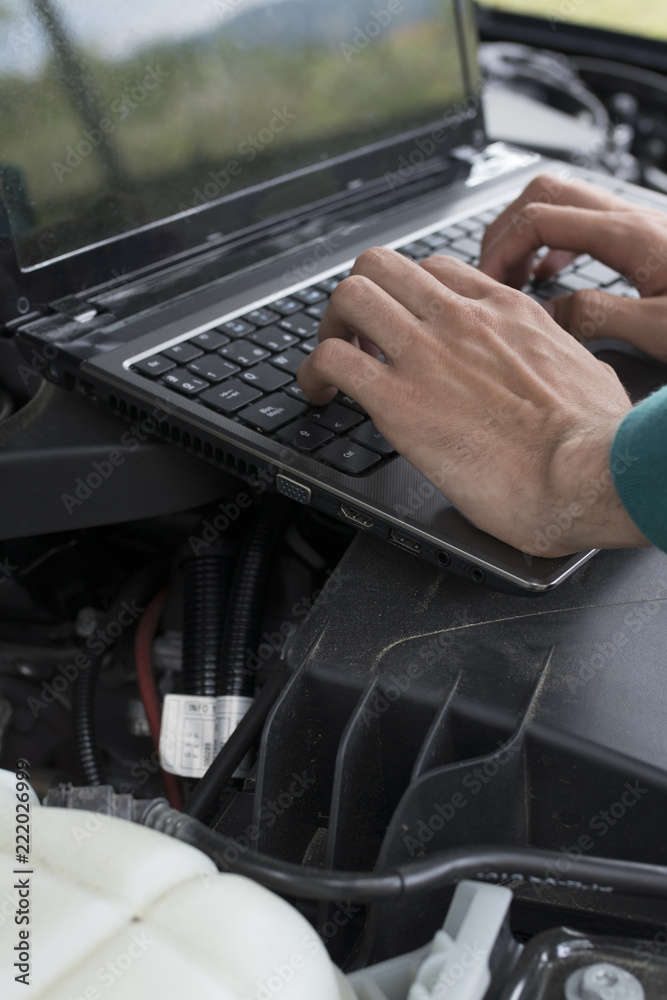 hands-on laptop checking car engine, breakdowns and repairs hands-on laptop checking car engine, breakdowns and repairs