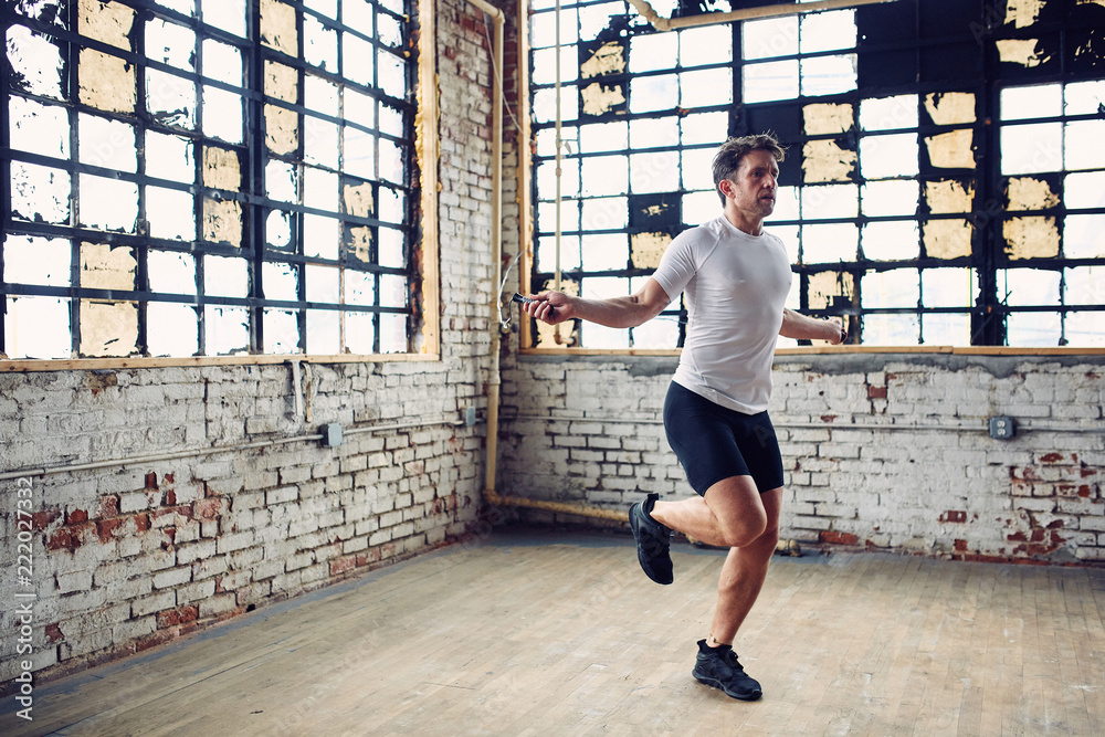 Fotografie Caucasian Man Jumps Rope