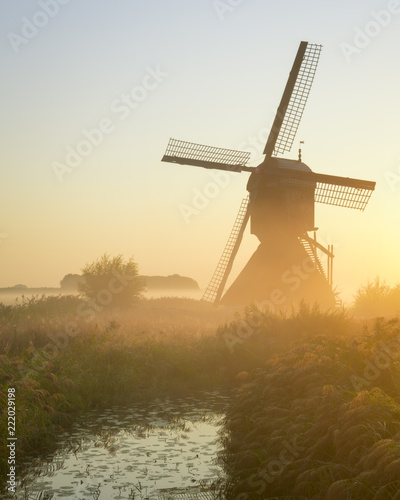 A beautiful misty morning at one of the windmills at Uppel. This Windmill is very traditional and is located in Netherlands.